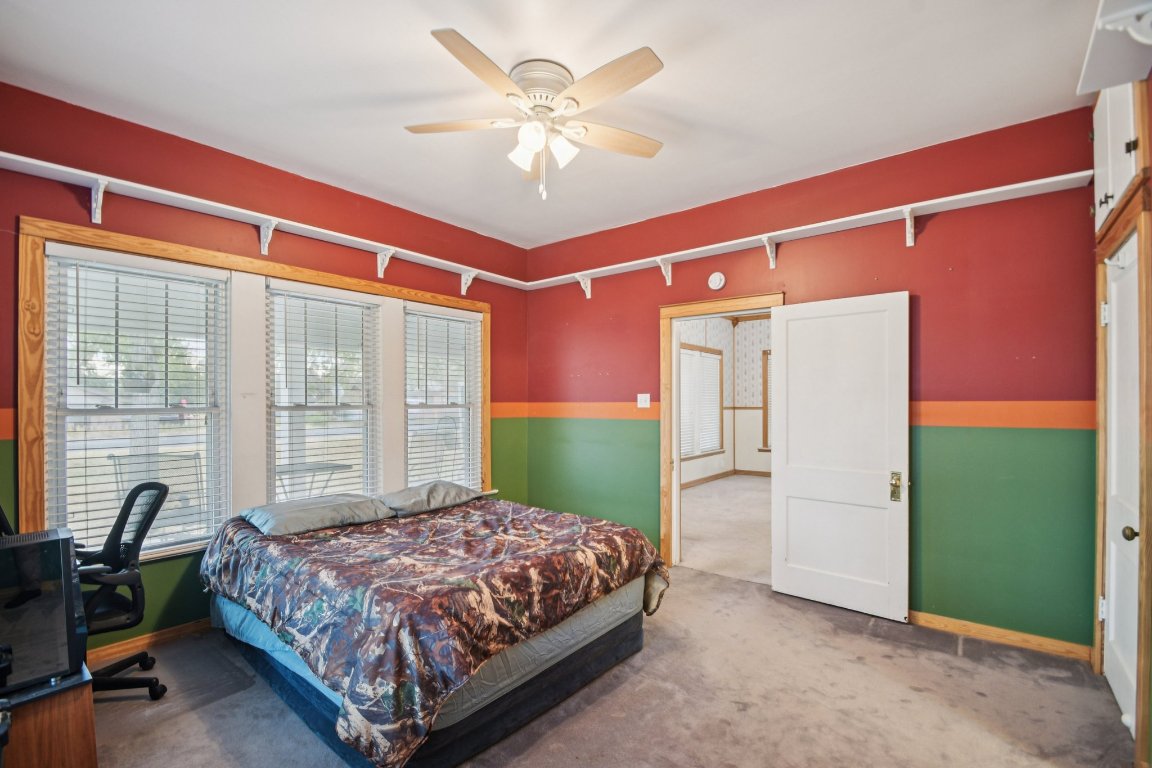 611 North Main Street Elgin, TX 78621 - Photo 27 of 34 Carpeted bedroom with a ceiling fan and baseboards
