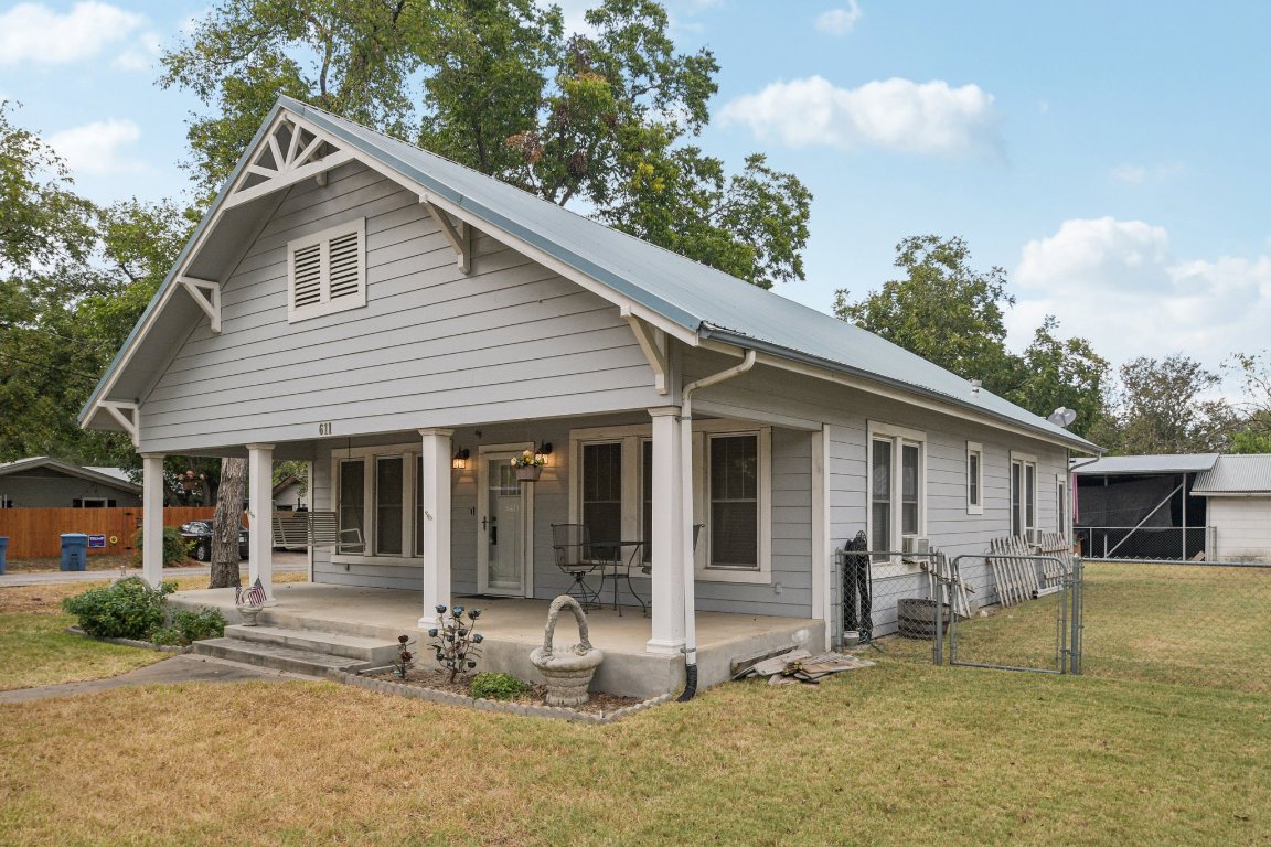 611 North Main Street Elgin, TX 78621 - Photo 4 of 34 View of front of home featuring covered porch, a gate, and a metal roof