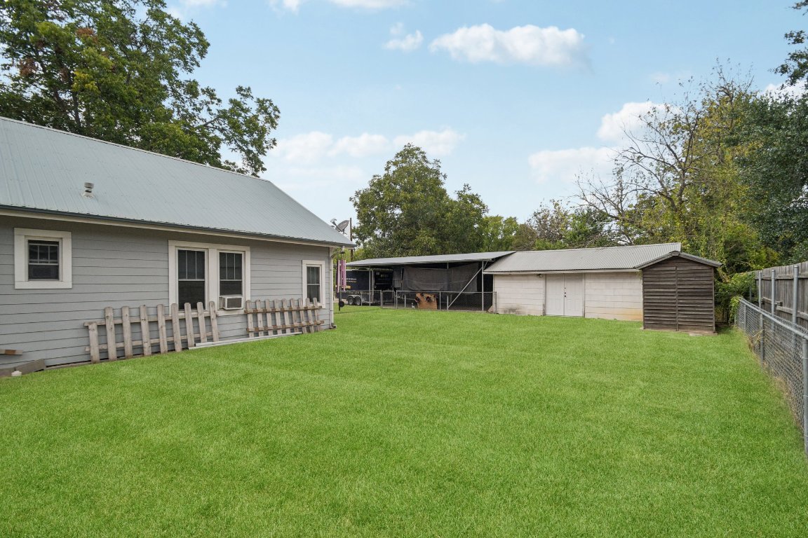 611 North Main Street Elgin, TX 78621 - Photo 6 of 34 Virtual staged green grass with a view of the two car garage and four car carport.