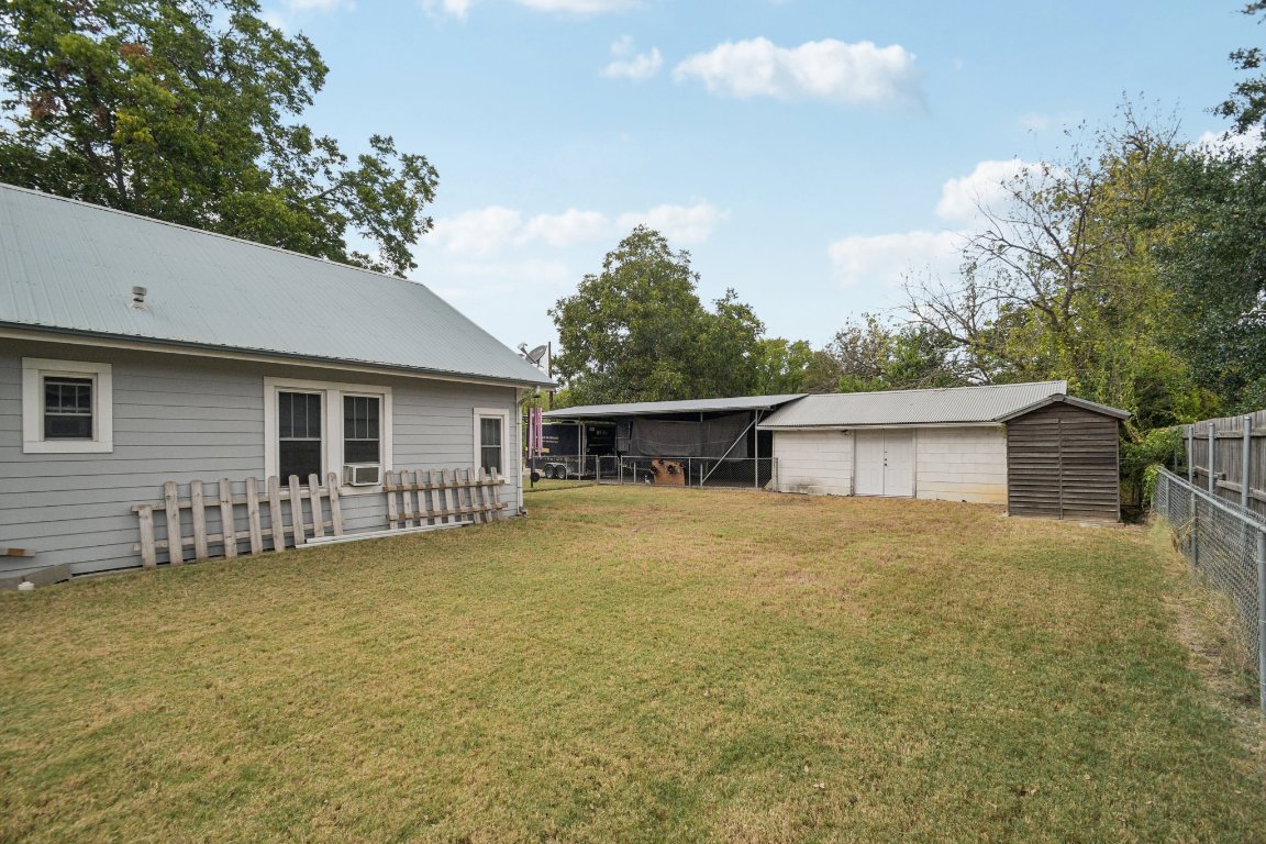 611 North Main Street Elgin, TX 78621 - Photo 7 of 34 View of yard with a pole building and an outbuilding