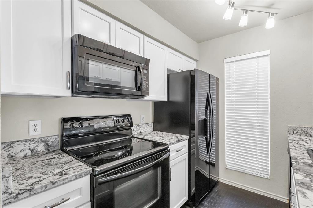 a kitchen with granite countertop cabinets and steel stainless steel appliances