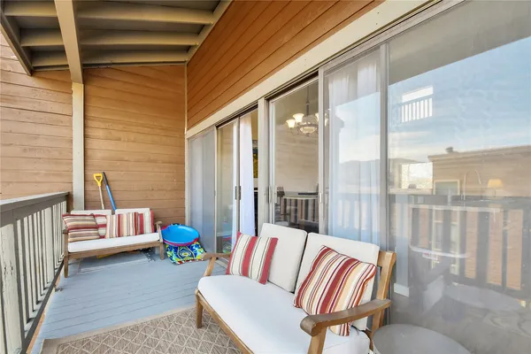 a balcony with furniture and a potted plant