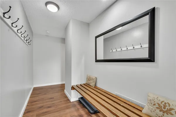 a view of a hallway with bed and a chandelier