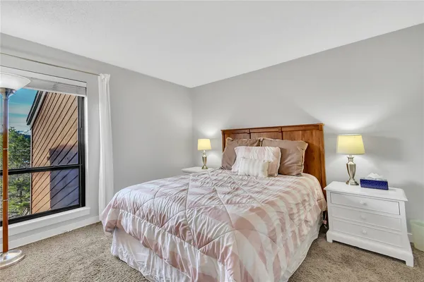 a bedroom with a large bed and a window