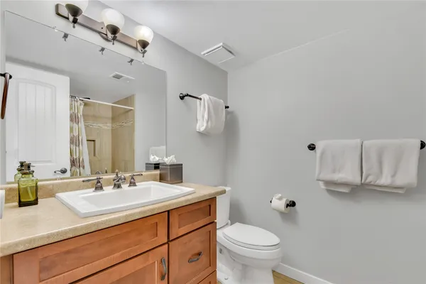 a bathroom with a sink toilet and mirror
