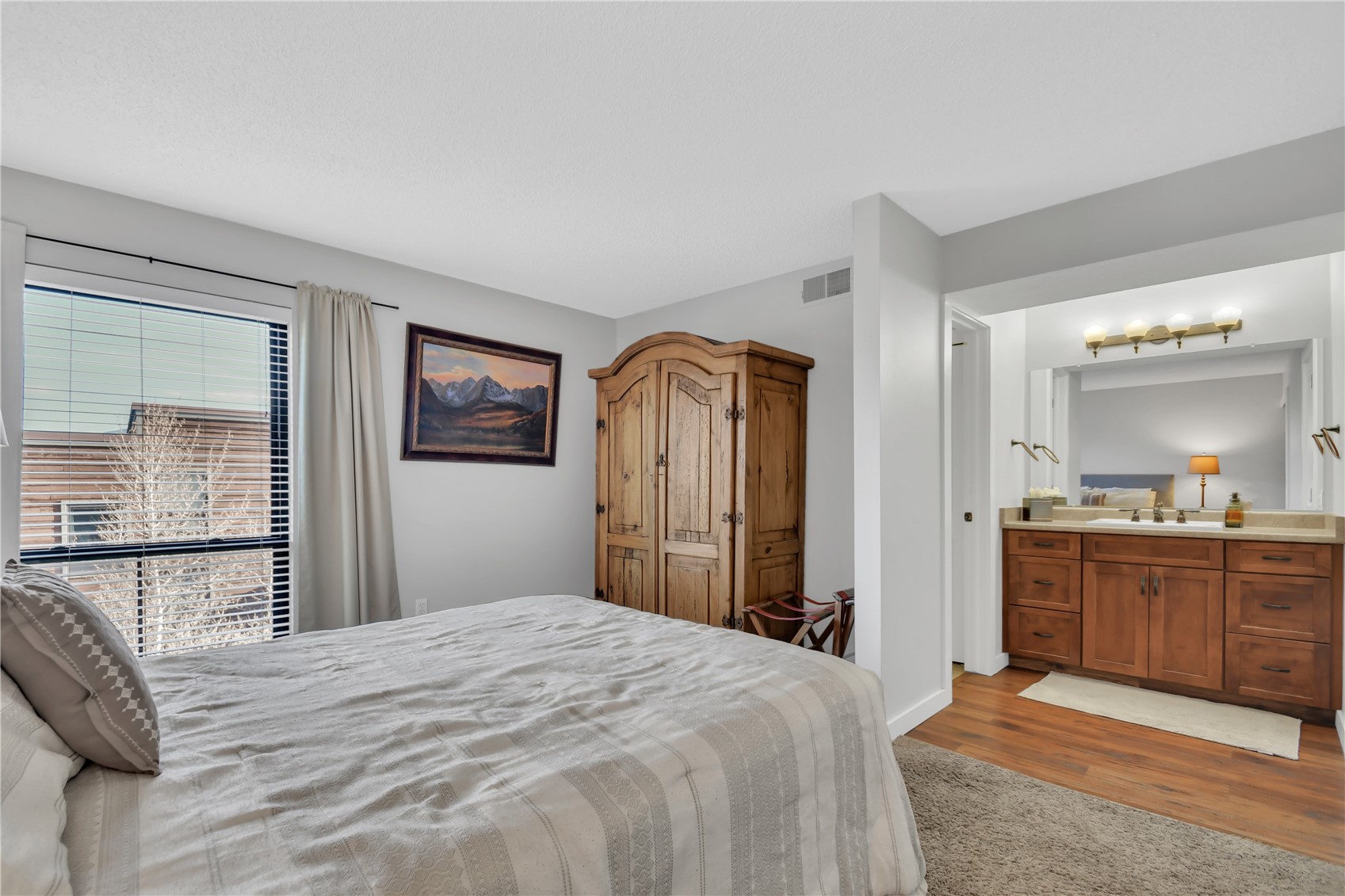 2710 Ryan Gulch Road, Unit 2731 Silverthorne, CO 80498 - Photo 22 of 39 a bedroom with a bed and dresser with mirror
