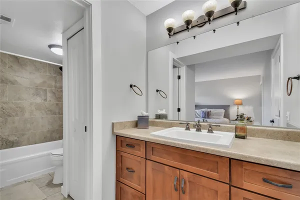 a bathroom with a sink double vanity granite toilet and shower