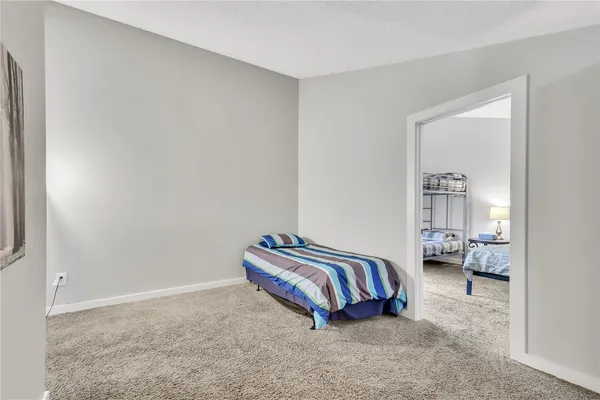 a spacious bedroom with a bed and window