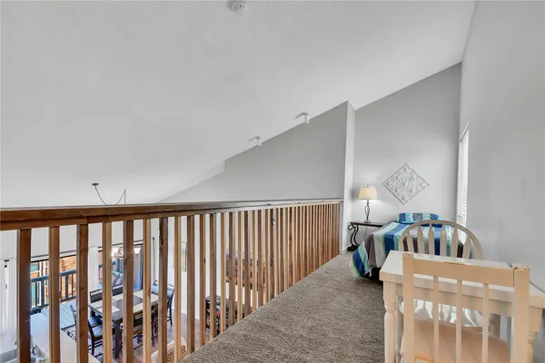 a living room with furniture and a baby crib next to a window