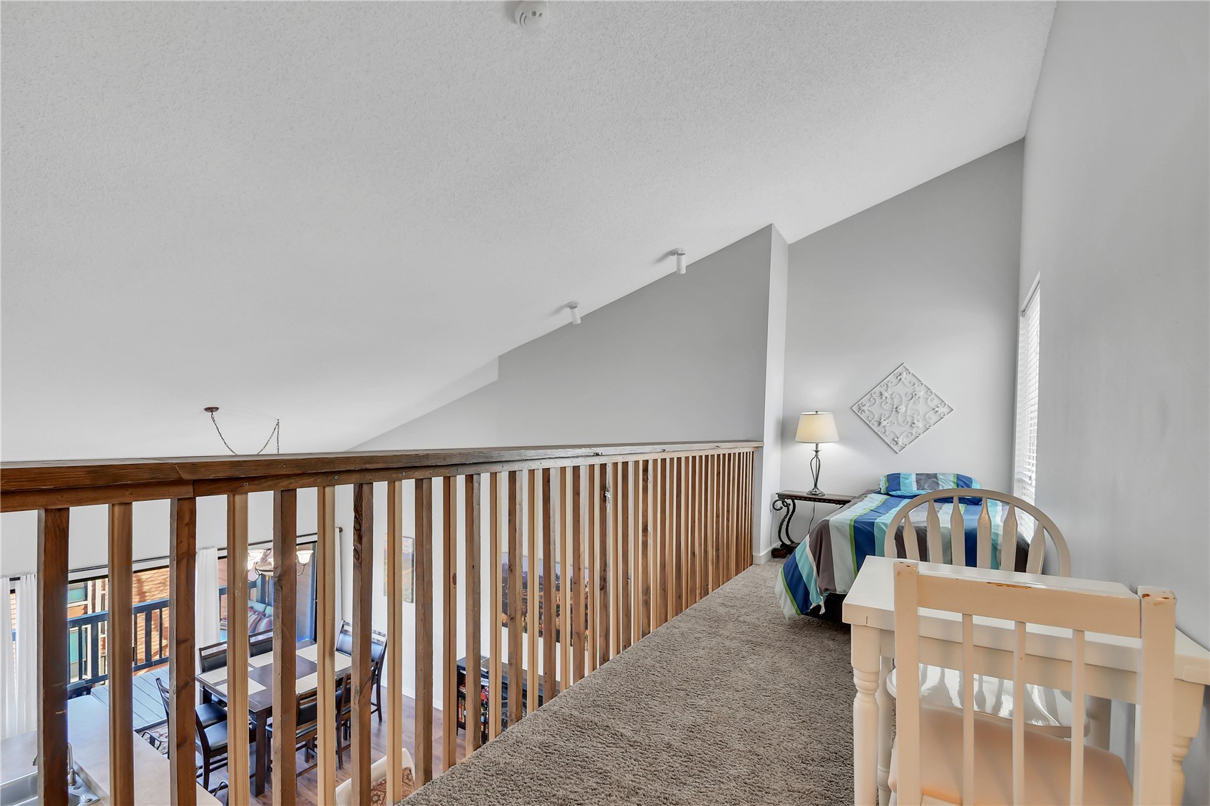 2710 Ryan Gulch Road, Unit 2731 Silverthorne, CO 80498 - Photo 28 of 39 a living room with furniture and a baby crib next to a window