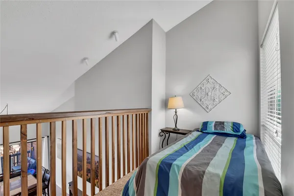 a bedroom with bed and a window