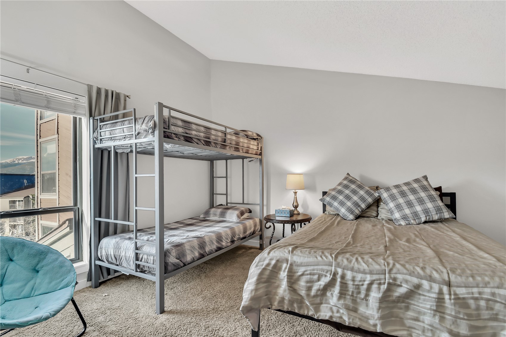 2710 Ryan Gulch Road, Unit 2731 Silverthorne, CO 80498 - Photo 31 of 39 a bedroom with a bed next to a window