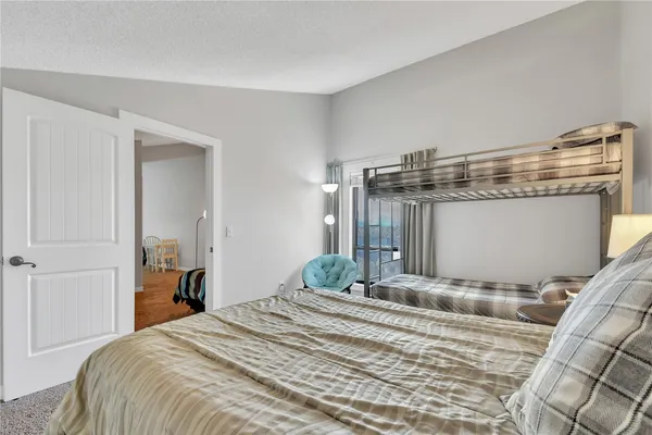 a bedroom with a bed and a mirror