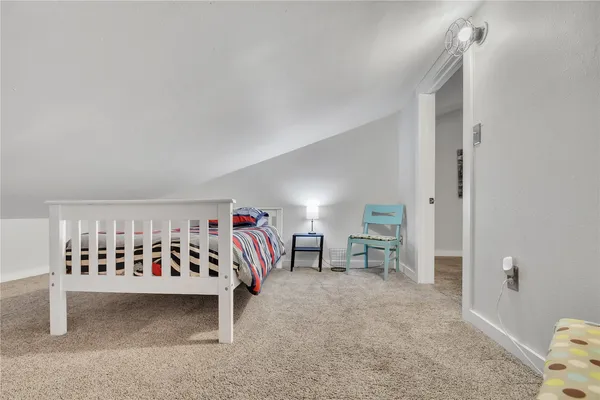 a view of a livingroom and a way to other room