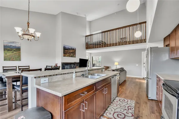a kitchen with a stove a kitchen island a dining table and chairs