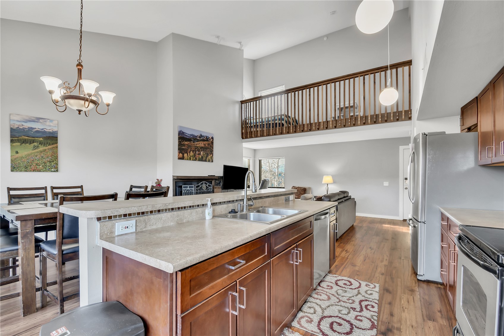 2710 Ryan Gulch Road, Unit 2731 Silverthorne, CO 80498 - Photo 10 of 39 a kitchen with a stove a kitchen island a dining table and chairs