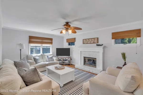 a living room with furniture fireplace and a flat screen tv