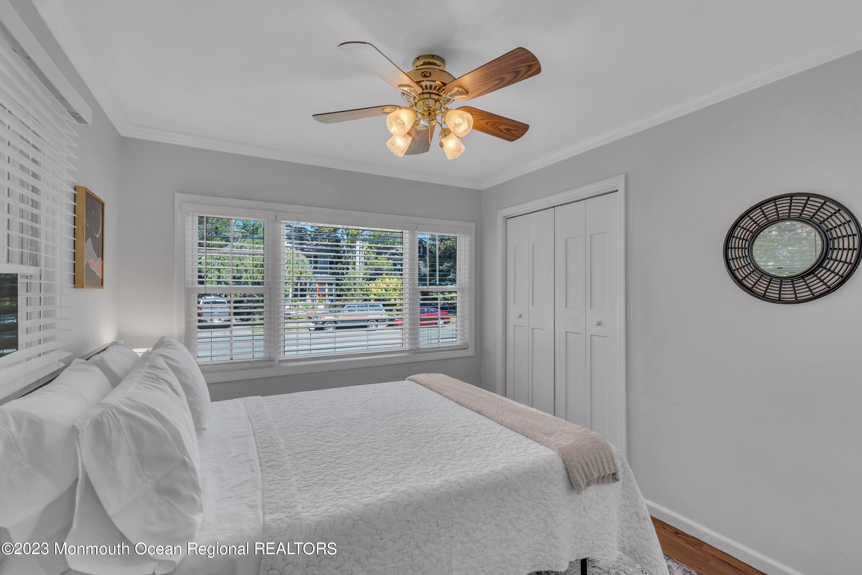 608 Brielle Avenue Brielle, NJ 08730 - Photo 19 of 56 a spacious bedroom with a large bed and a chandelier