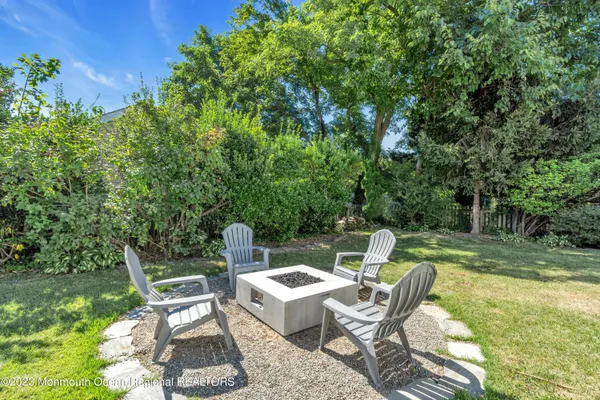 a view of a chairs and table in the garden