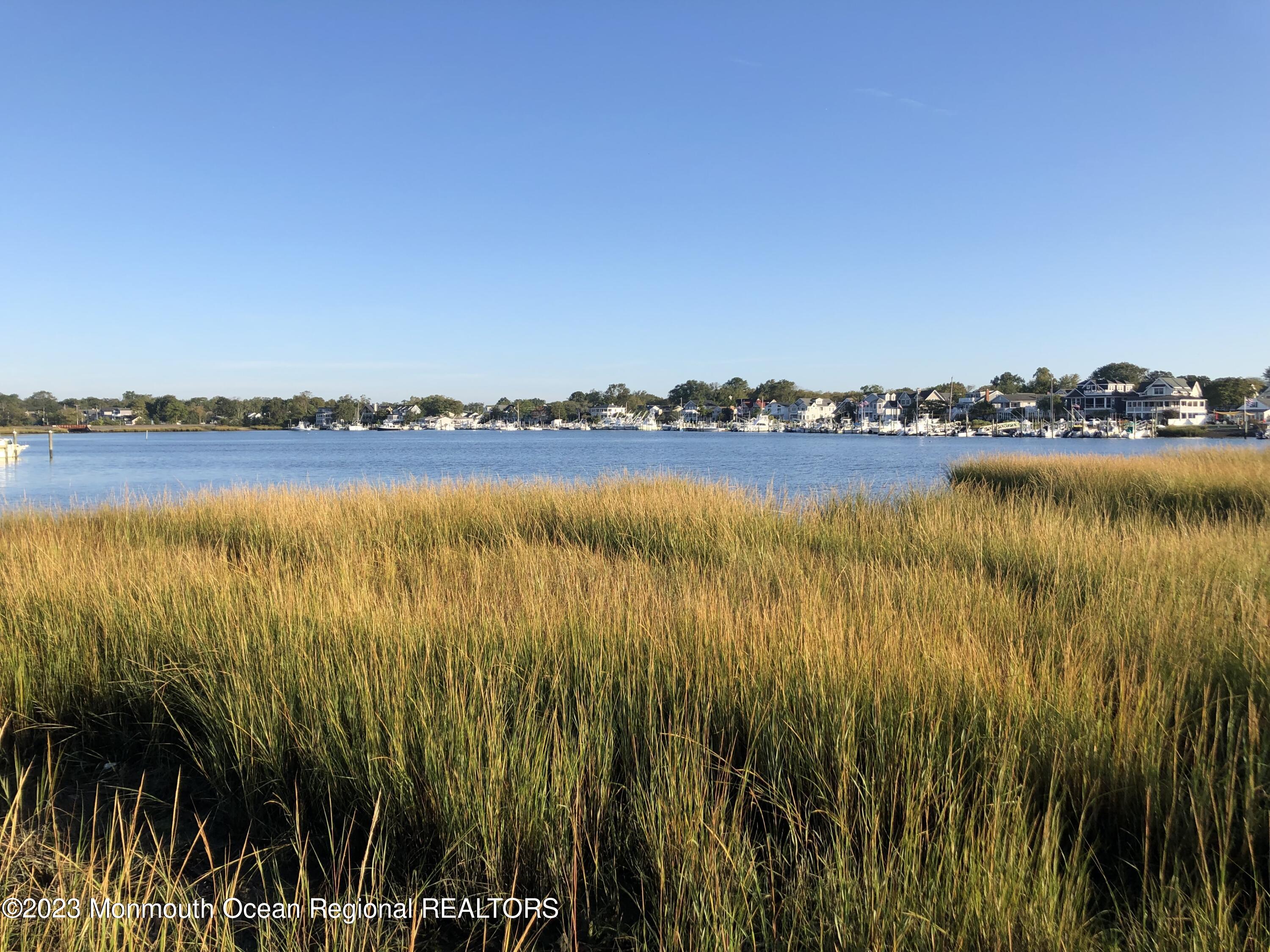608 Brielle Avenue Brielle, NJ 08730 - Photo 25 of 56 a view of a lake with houses in the background