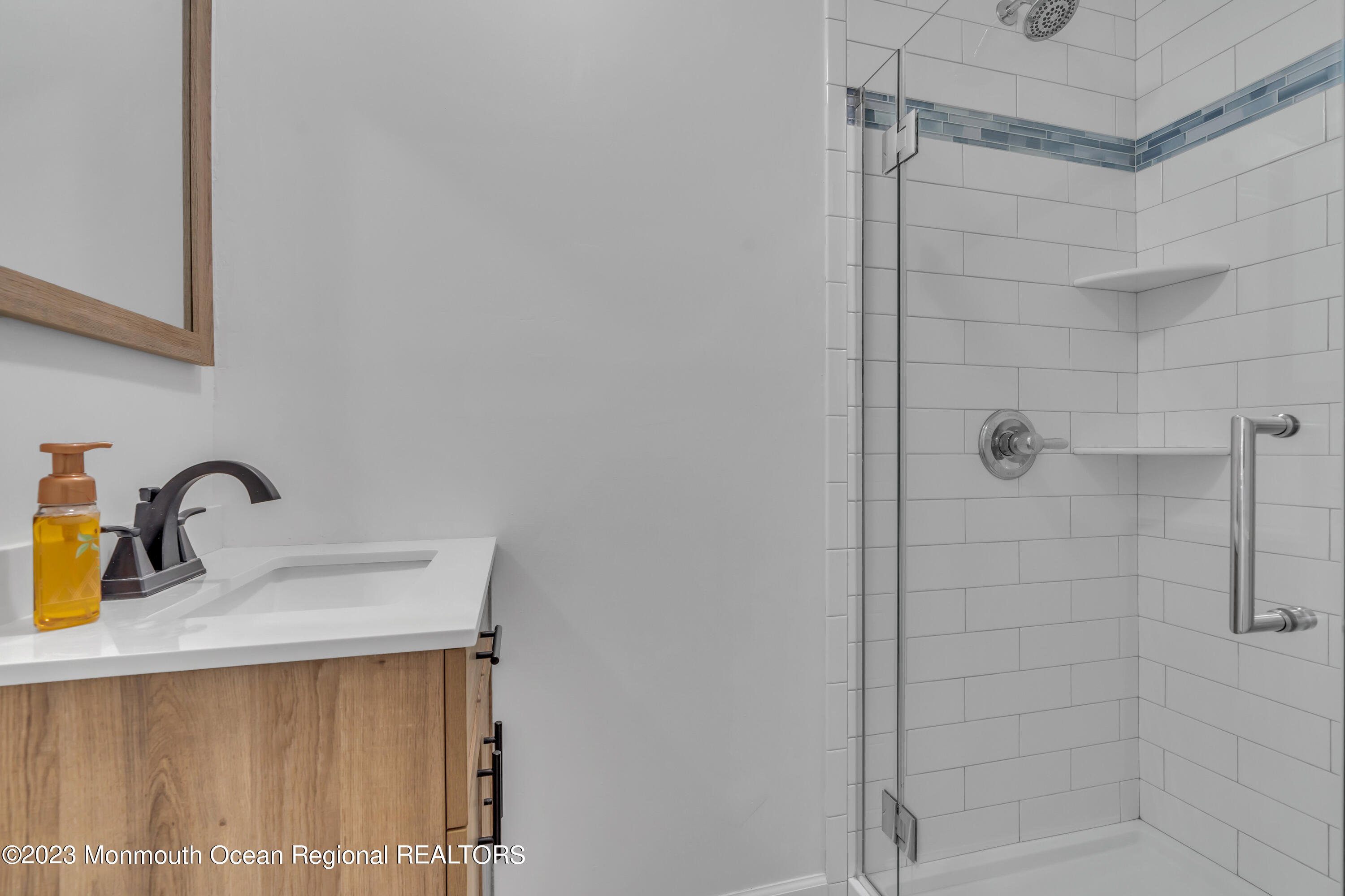 608 Brielle Avenue Brielle, NJ 08730 - Photo 32 of 56 a bathroom with a sink shower and a mirror