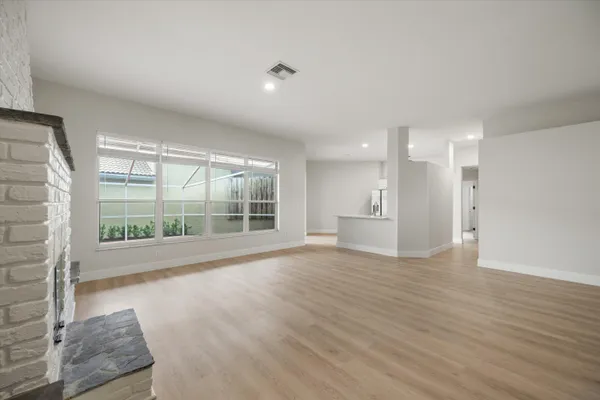 a view of wooden floor and windows in a room