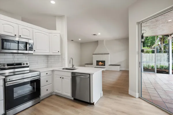 a kitchen with a stove a sink and a microwave