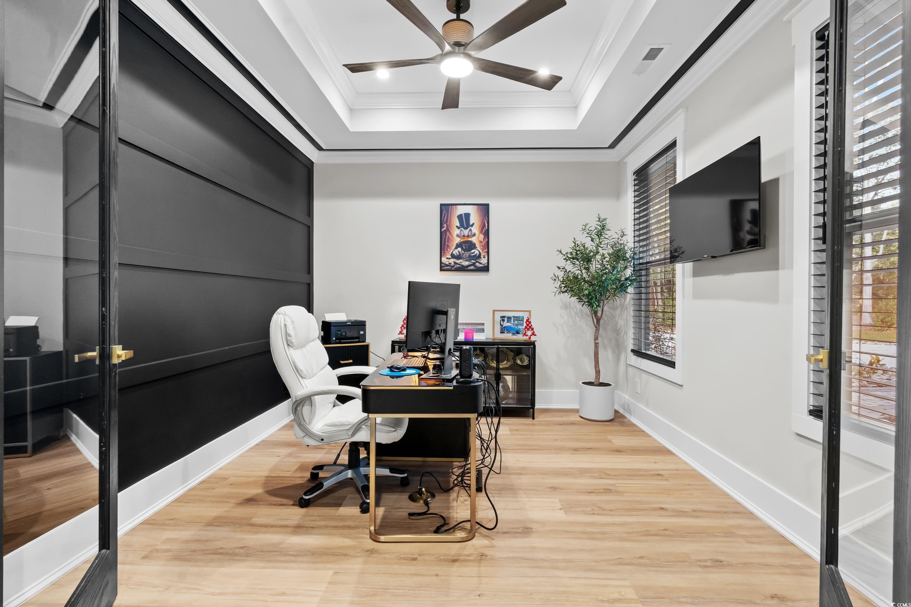 Home office with a ceiling fan, crown molding, lig