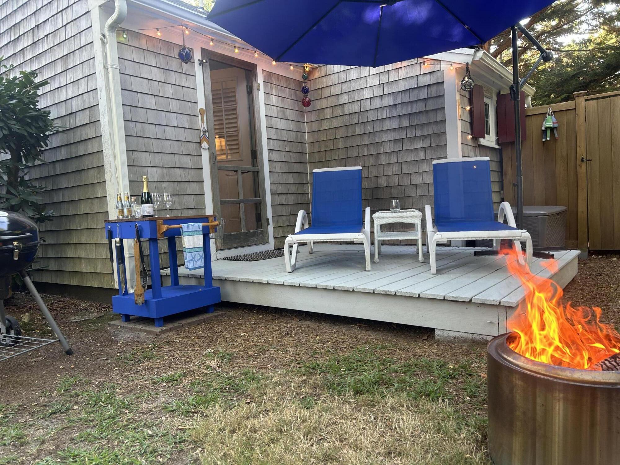 785 State Highway, Unit 9 Eastham, MA 02642 - Photo 17 of 30 a backyard of a house with outdoor seating