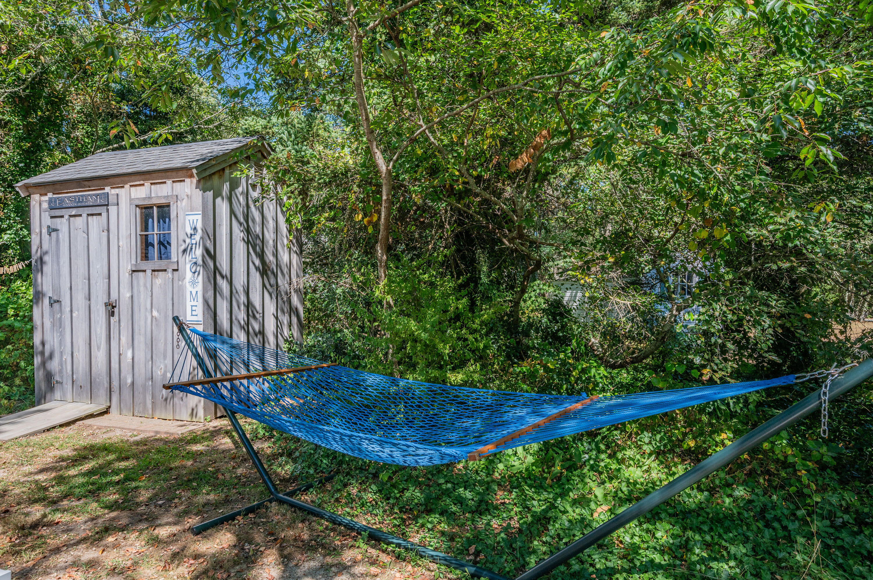 785 State Highway, Unit 9 Eastham, MA 02642 - Photo 22 of 30 a view of a chair and table in backyard