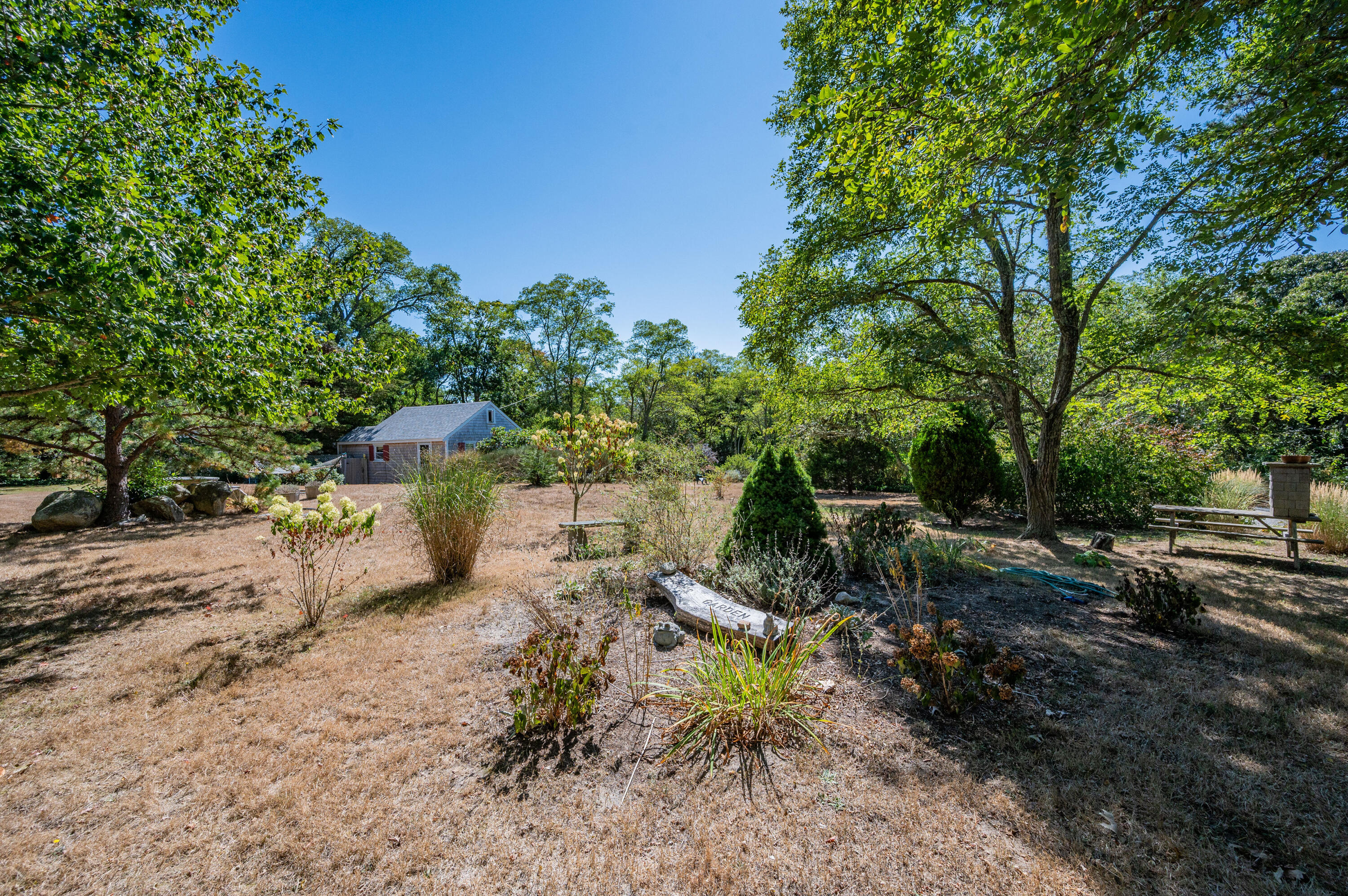 785 State Highway, Unit 9 Eastham, MA 02642 - Photo 29 of 30 a backyard of a house with lots of green space