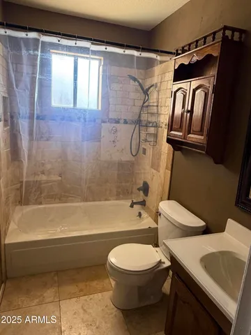a bathroom with a toilet a sink and bathtub