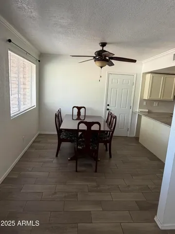 a view of a dining room with furniture and window