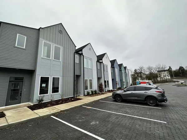 a view of a cars park in front of a house
