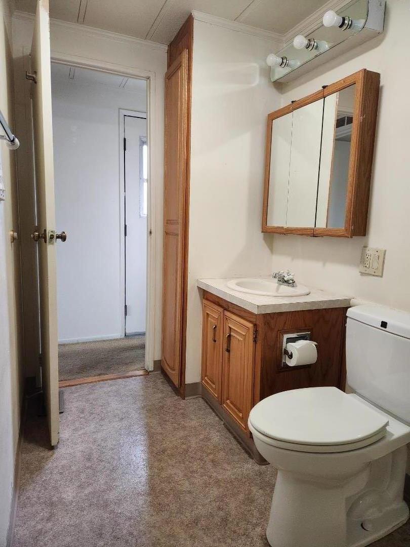 1556 Crown Road, Unit 1556 Petaluma, CA 94954 - Photo 20 of 21 a bathroom with a toilet a sink a mirror and vanity