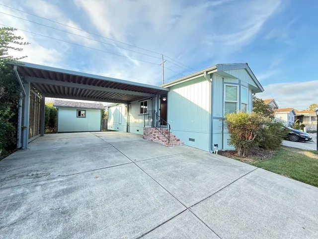 a view of a house with a yard and garage