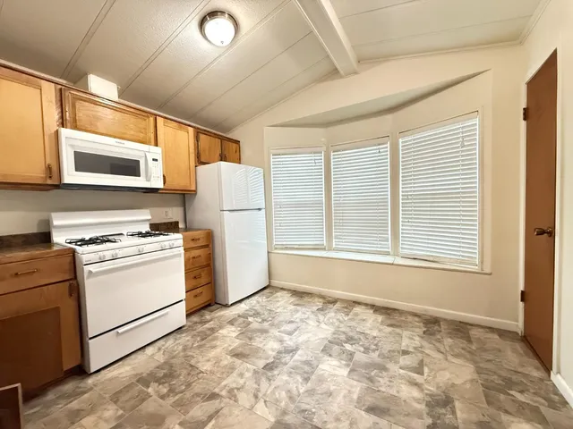a kitchen with a stove a sink and a refrigerator