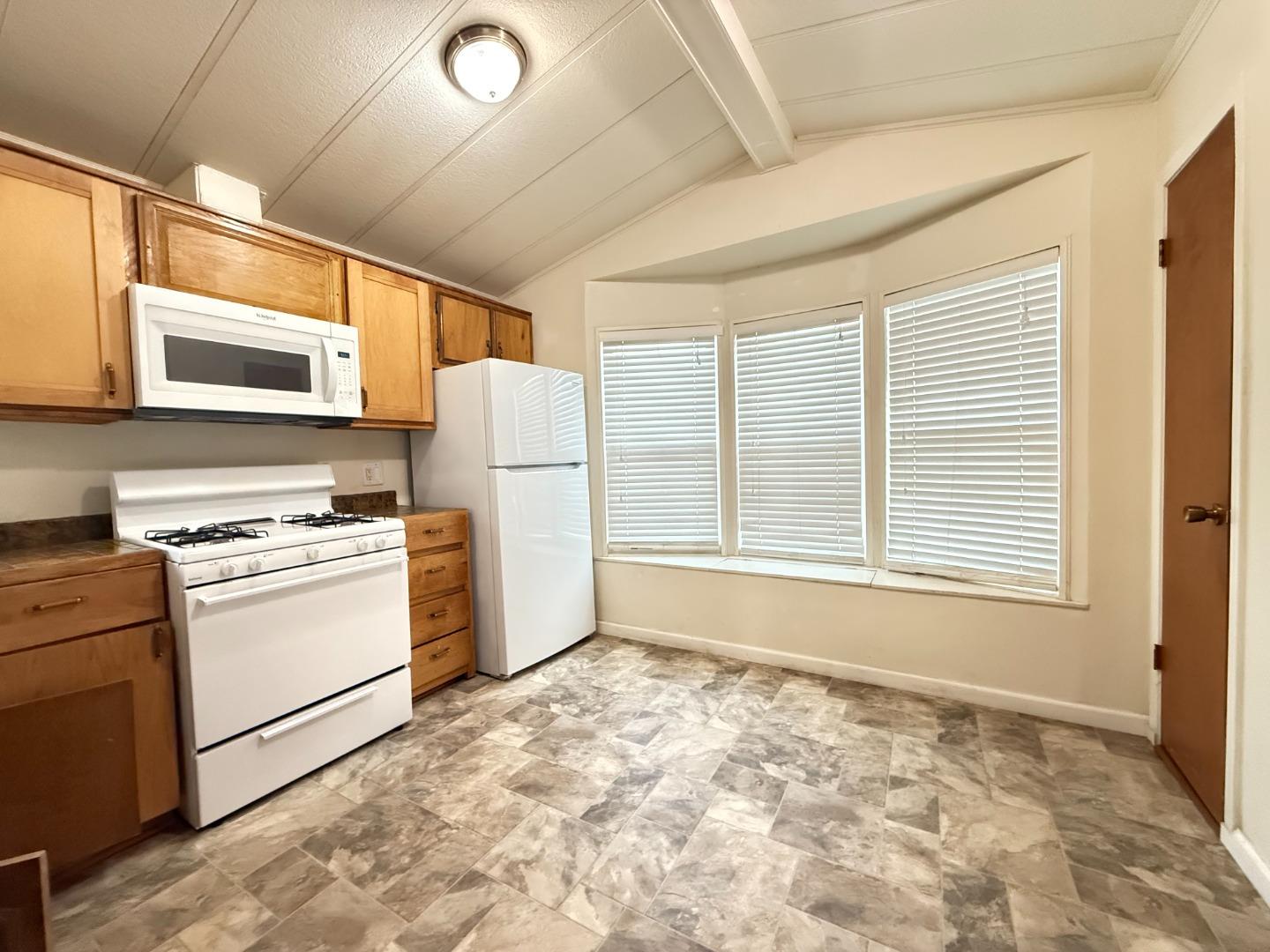 1556 Crown Road, Unit 1556 Petaluma, CA 94954 - Photo 8 of 21 a kitchen with a stove a sink and a refrigerator