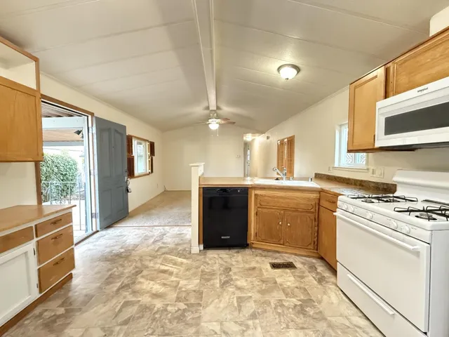 a kitchen with a stove a sink and a refrigerator