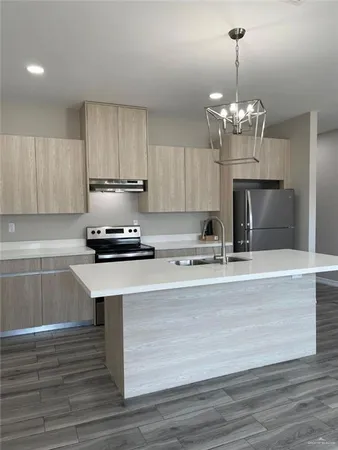 a view of kitchen with sink stainless steel appliances and cabinets
