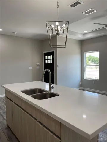 a kitchen with a table chairs and a chandelier