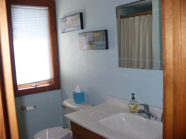 18430 East Twombly Road Rochelle, IL 61068 - Photo 13 of 25 a bathroom with a sink a toilet and a mirror