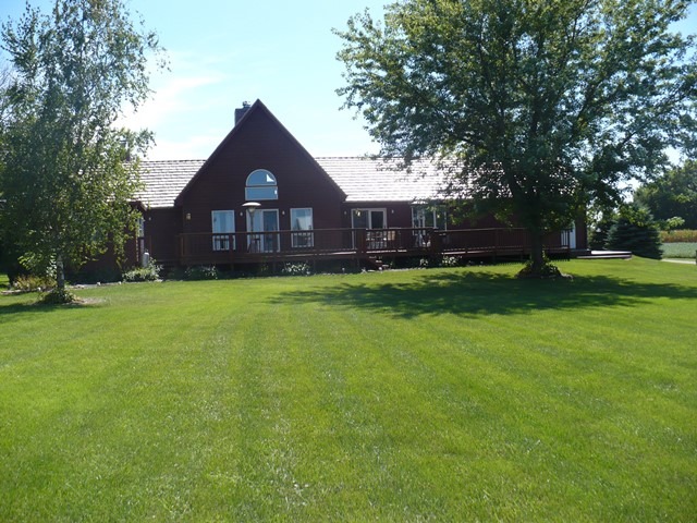 18430 East Twombly Road Rochelle, IL 61068 - Photo 20 of 25 a large house with a big yard and large trees