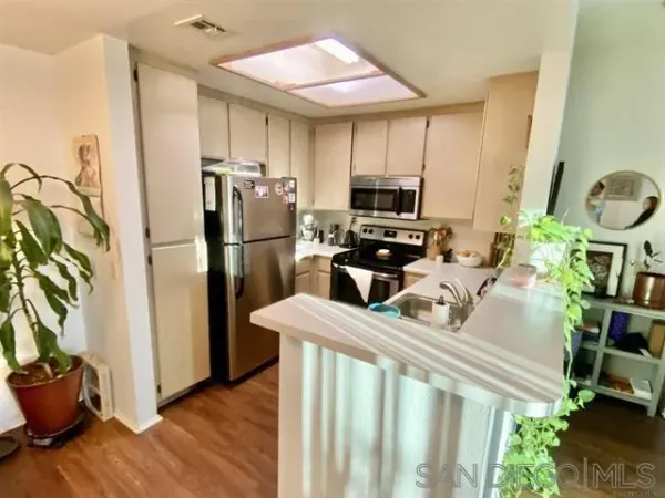 a kitchen with sink refrigerator and microwave