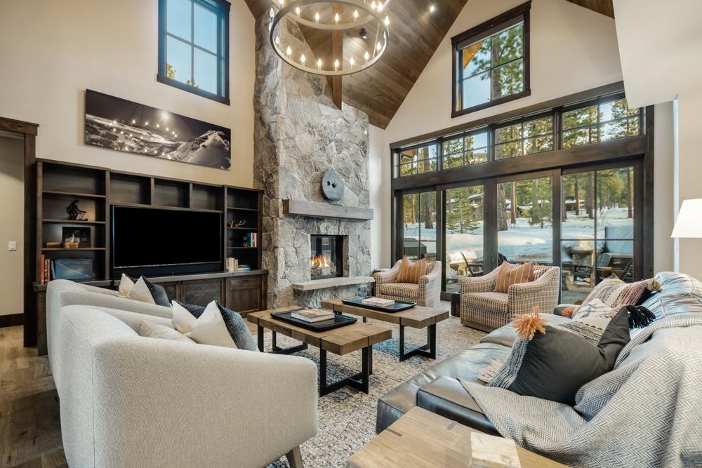 8454 Newhall Drive Truckee, CA 96161 - Photo 1 of 21 a living room with furniture a floor to ceiling window and a flat screen tv