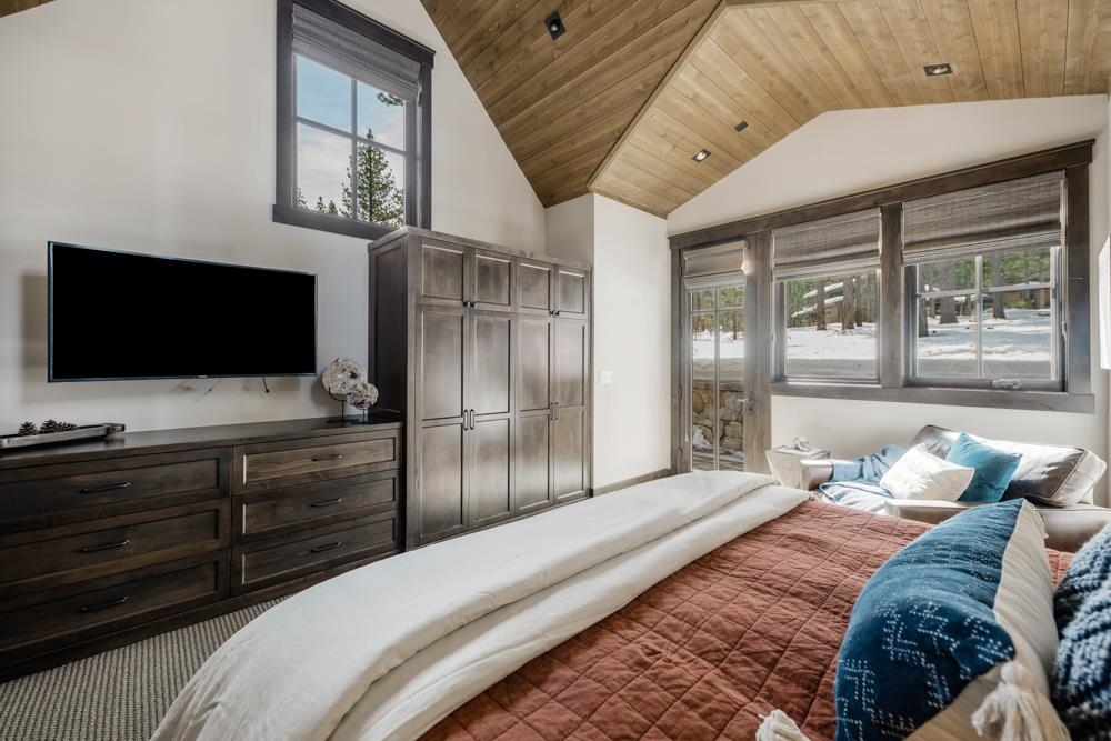 8454 Newhall Drive Truckee, CA 96161 - Photo 15 of 21 a bedroom with a large bed and a flat screen tv