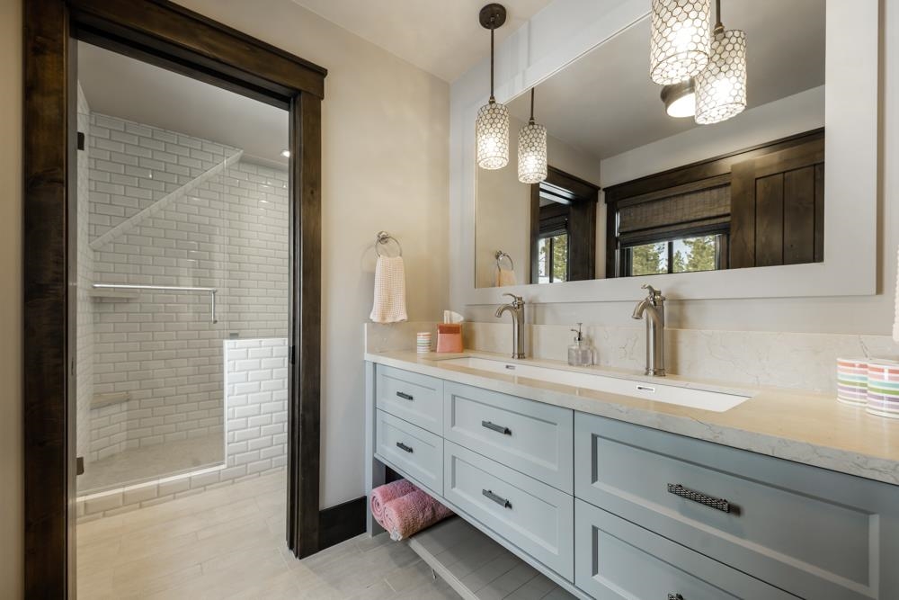 8454 Newhall Drive Truckee, CA 96161 - Photo 17 of 21 a bathroom with a double vanity sink a mirror and a shower