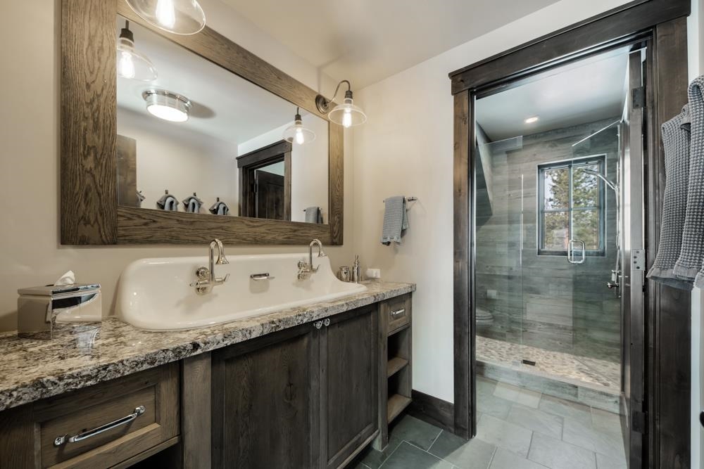 8454 Newhall Drive Truckee, CA 96161 - Photo 19 of 21 a bathroom with a granite countertop sink mirror and double