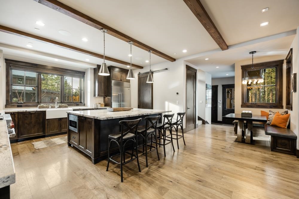 8454 Newhall Drive Truckee, CA 96161 - Photo 9 of 21 a large dining space with furniture a rug and a painting