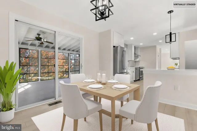 a living room with furniture a flat screen tv and a large window